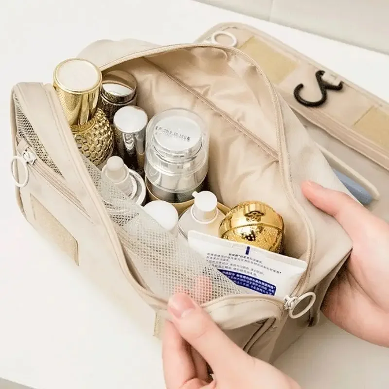 Beige cosmetic bag filled with various beauty products.