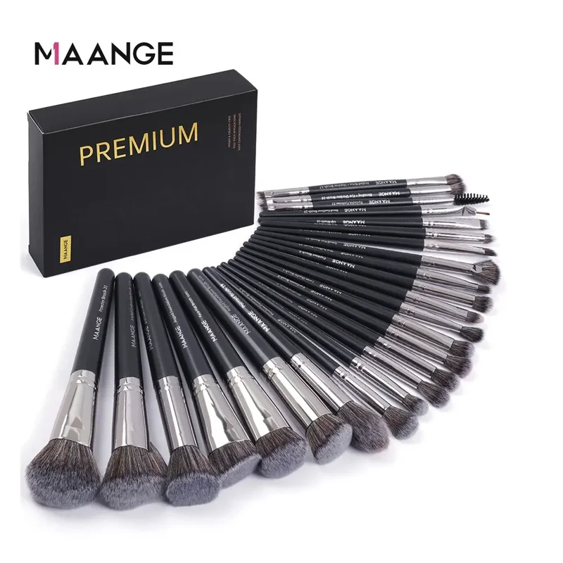 A set of MAANGE premium makeup brushes arranged in a fan shape. The brushes are black and silver with soft bristles. They come in a black box that says "PREMIUM" on it. The background is white.