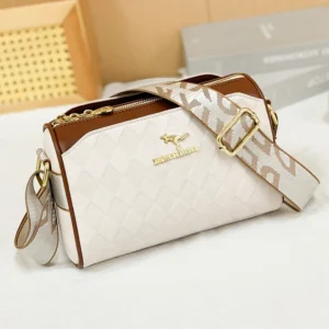 Close-up view of a stylish white and brown quilted handbag with a unique patterned strap. The bag has a gold kangaroo logo and a zipper closure.