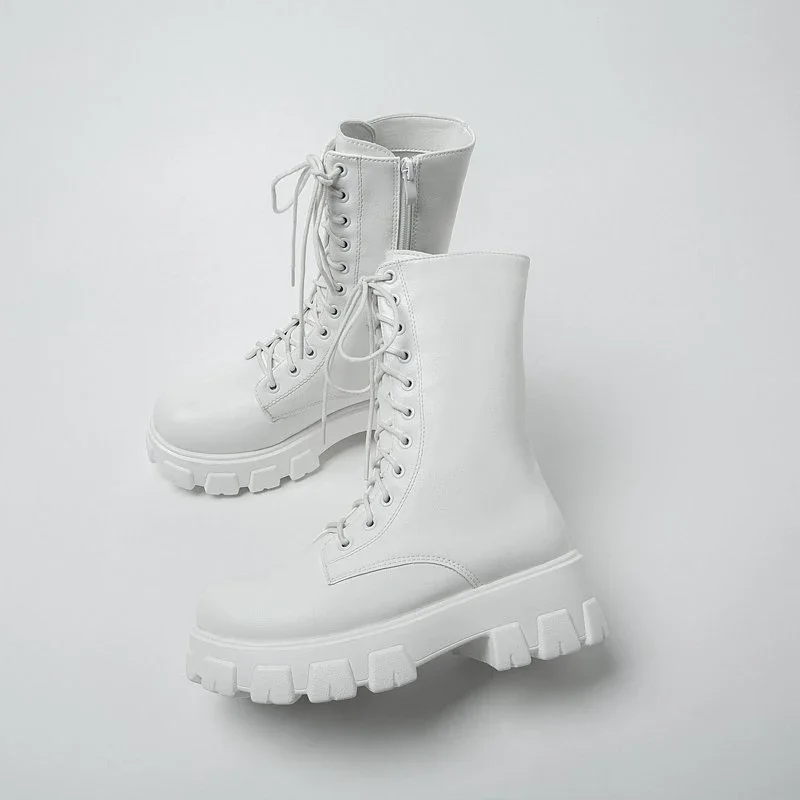 A pair of white chunky platform lace-up boots.