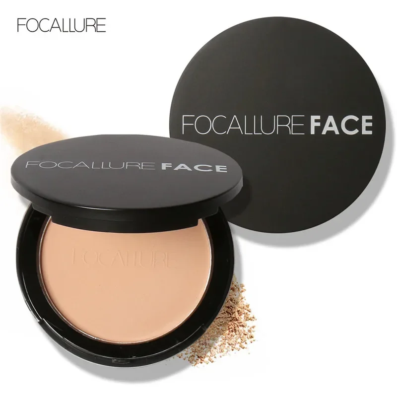 A compact of pressed powder by the brand FOCALLURE. The compact is black with silver lettering, and the powder is a light beige color.