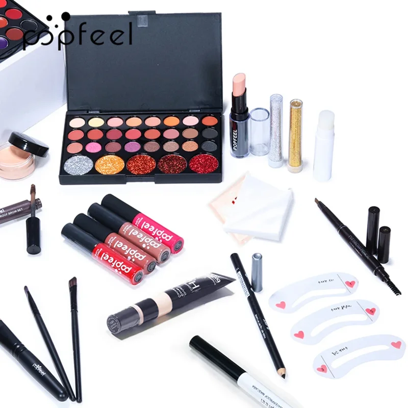 A flatlay showcasing a Popfeel makeup kit, featuring an eyeshadow palette, lipsticks, eyeliner, mascara, and other cosmetics.