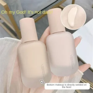 Two bottles of Gauze Beauty Liquid Foundation stand upright, partially obscured by a hand and sheer fabric. The bottles are a pale pink, and one is slightly tilted toward the viewer. A close-up inset shows the foundation's creamy texture. Text overlays describe the product and its effect.