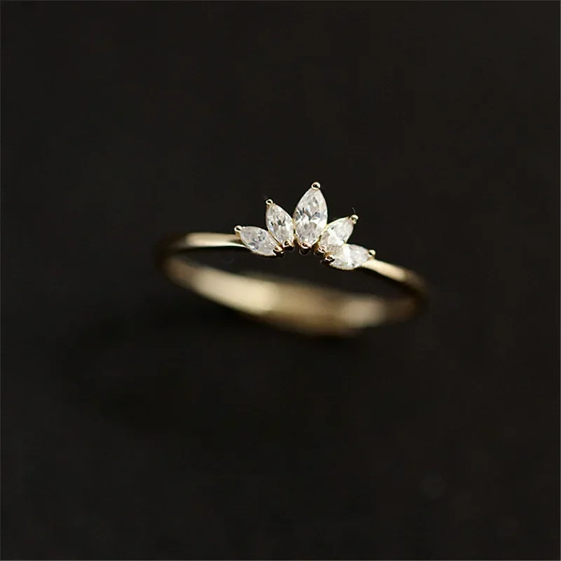 A delicate gold ring adorned with five marquise-cut diamonds, arranged in a crown-like formation.
