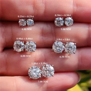 Close-up shot of a hand showcasing a variety of diamond stud earrings. Each pair is clearly labeled with its carat weight and size in millimeters.