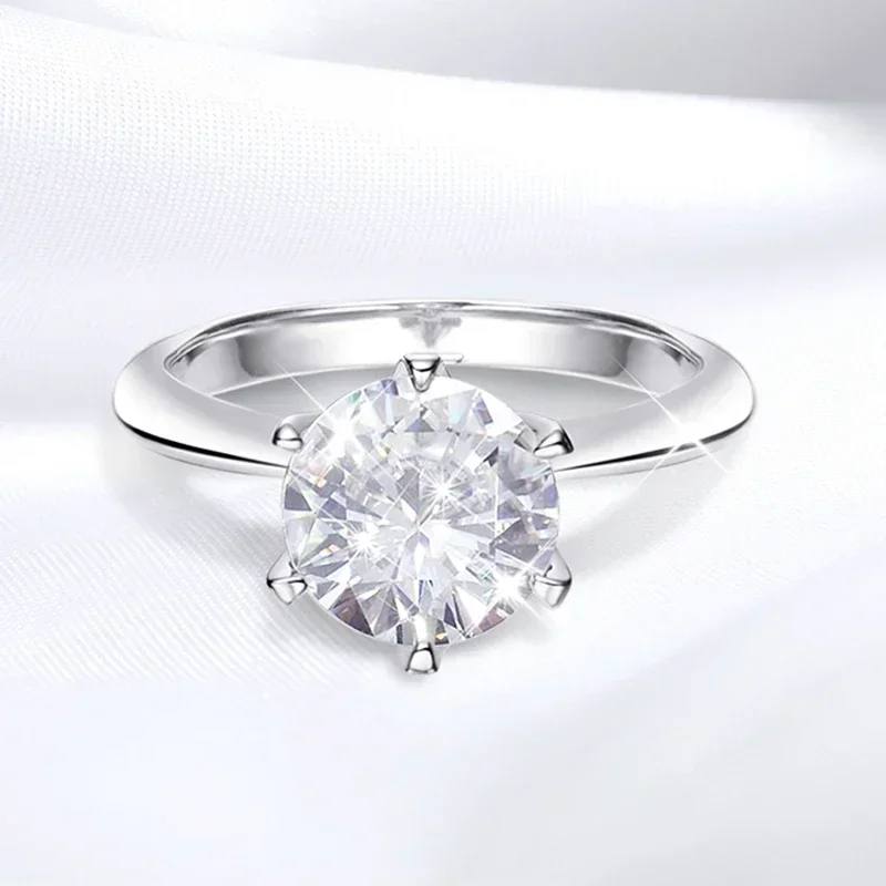 A close-up shot of a solitaire diamond ring on a white background.