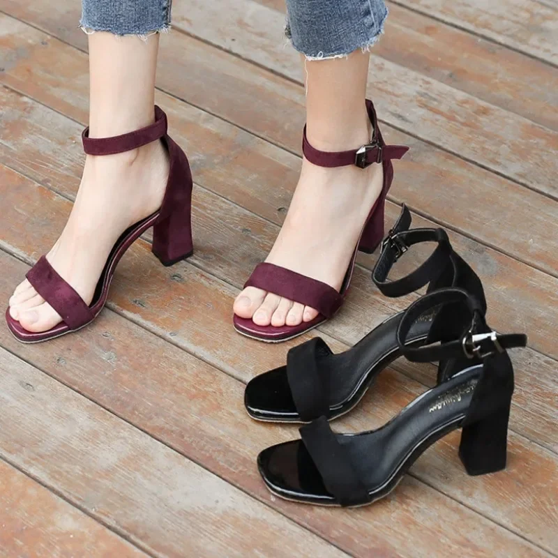 Two pairs of women's heeled sandals. One pair is burgundy and the other is black. Both pairs have ankle straps and block heels.
