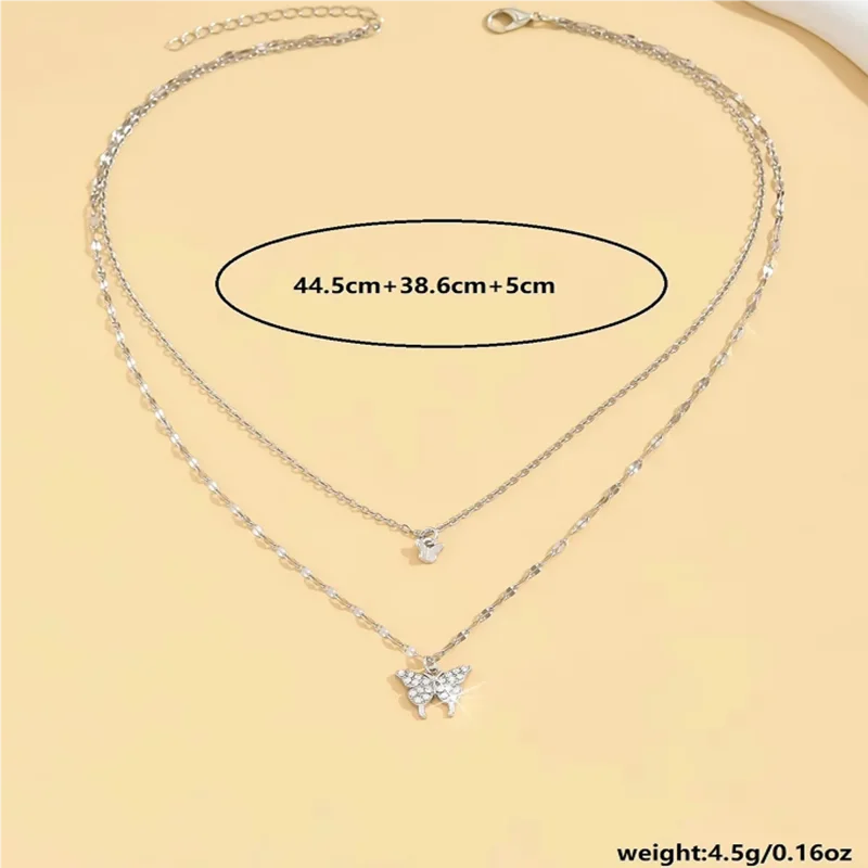 A silver double layered necklace with a star and butterfly pendant. The necklace is 44.5cm + 38.6cm + 5cm long and weighs 4.5g/0.16oz.