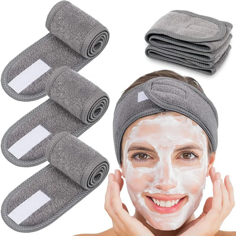 Three gray fabric headbands rolled up and one gray fabric headband on a woman's head. The woman is applying a face mask.