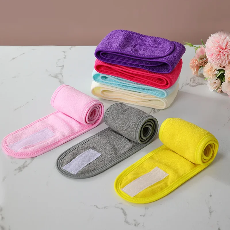Colorful soft terry cloth headbands on a marble surface.