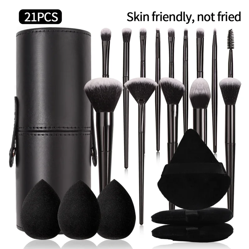 A set of 21 black makeup brushes and sponges in a black leather case.