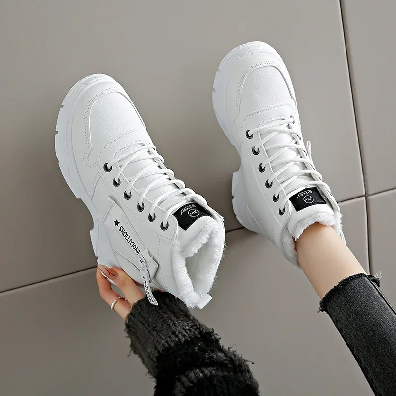 A pair of white high-top sneakers with a fuzzy lining. The sneakers have black laces and a zipper on the side. The sneakers are on a person's feet, and the person's legs are visible.