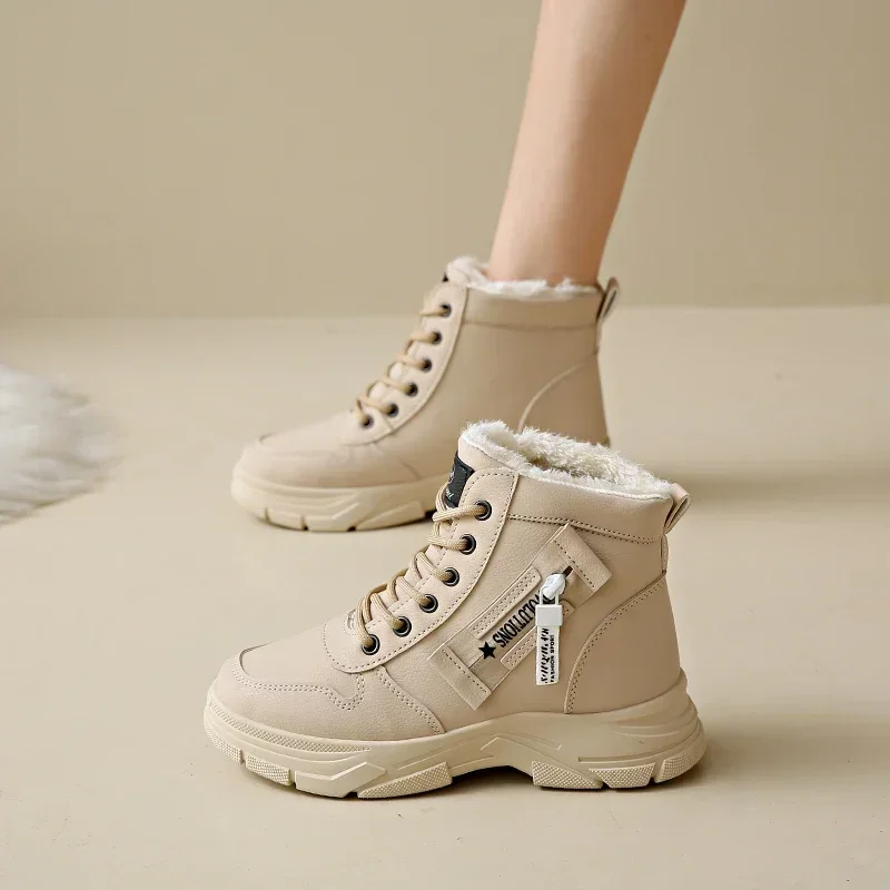 A pair of beige ankle boots with thick soles and fur lining. The boots are lace-up and have a zipper on the side. The boots are shown on a model's feet.