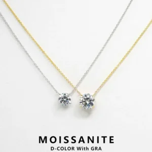 Two necklaces with a single round brilliant cut moissanite pendant, one with a gold chain and the other with a silver chain. The pendants are both D-color with GRA grading.