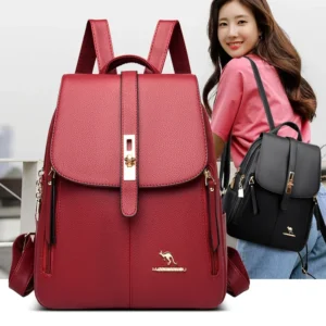 Two women's backpacks, one red and one black, are shown in the image. The red backpack is larger and in the foreground, while the black backpack is smaller and being worn by a woman in the background. Both backpacks have gold-colored hardware and zippers.