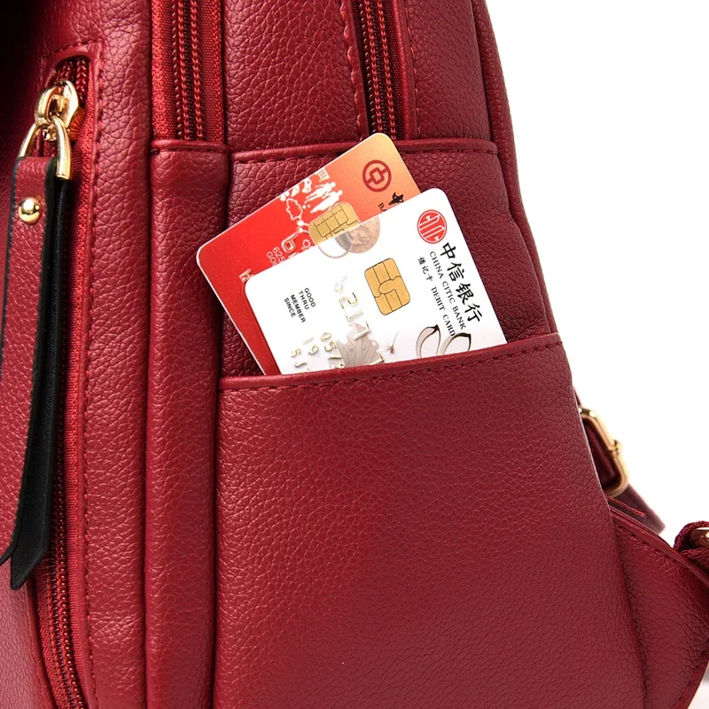 Close-up of a red backpack with a card holder, showing a China CITIC Bank debit card inside.